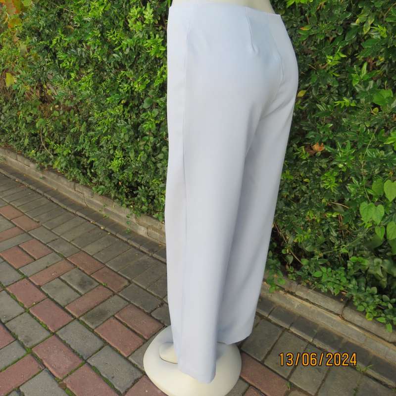 Bandless carolina blue straight legged dress pants in 100% polyester. Size 36 by SMILEY. As new