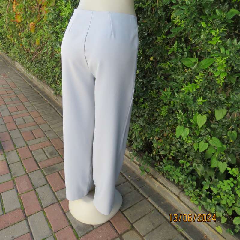 Bandless carolina blue straight legged dress pants in 100% polyester. Size 36 by SMILEY. As new