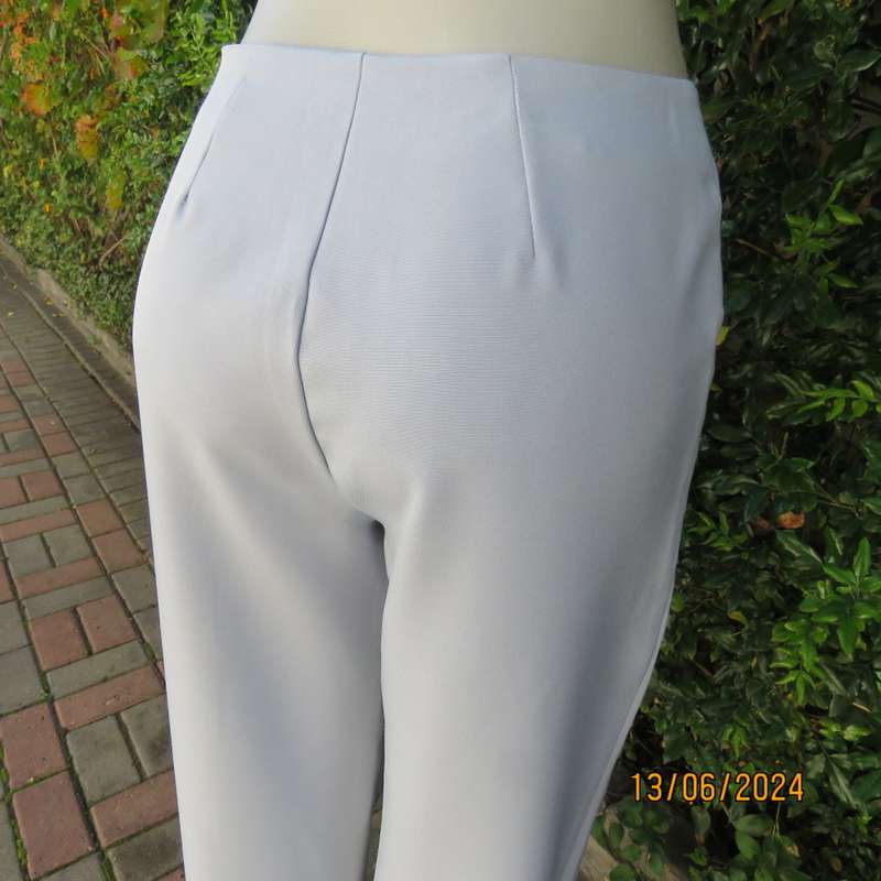 Bandless carolina blue straight legged dress pants in 100% polyester. Size 36 by SMILEY. As new