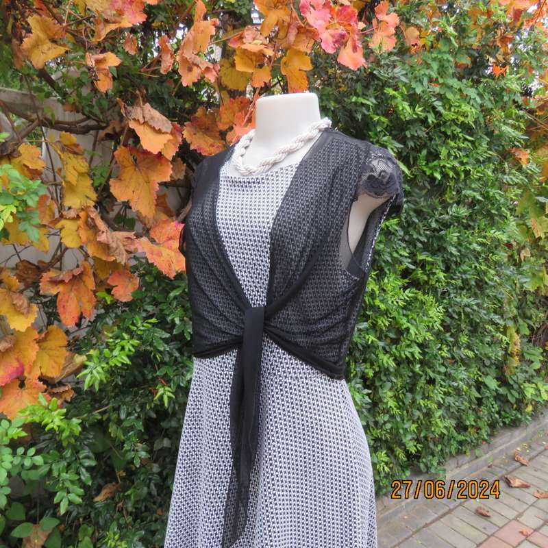 Handy crossover sheer polyester black bolero. Long straps to tie, Tiny lace capped sleeves. Size 38