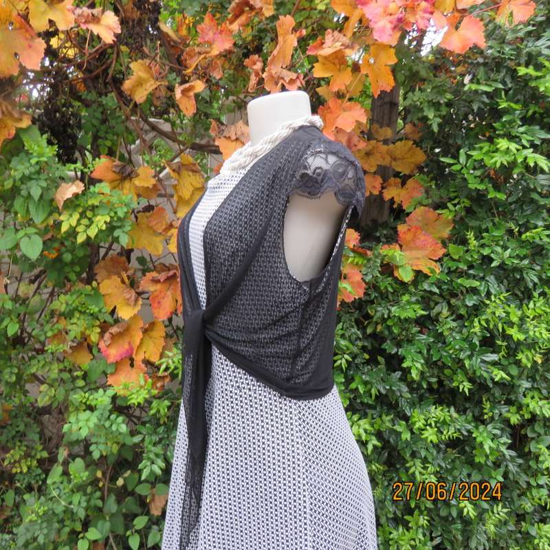 Handy crossover sheer polyester black bolero. Long straps to tie, Tiny lace capped sleeves. Size 38