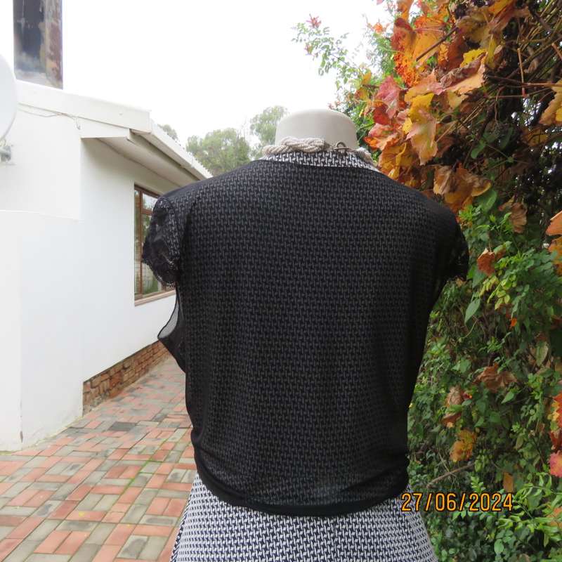 Handy crossover sheer polyester black bolero. Long straps to tie, Tiny lace capped sleeves. Size 38