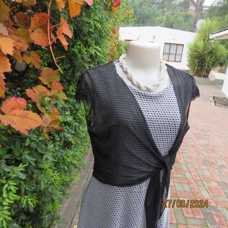 Handy crossover sheer polyester black bolero. Long straps to tie, Tiny lace capped sleeves. Size 38