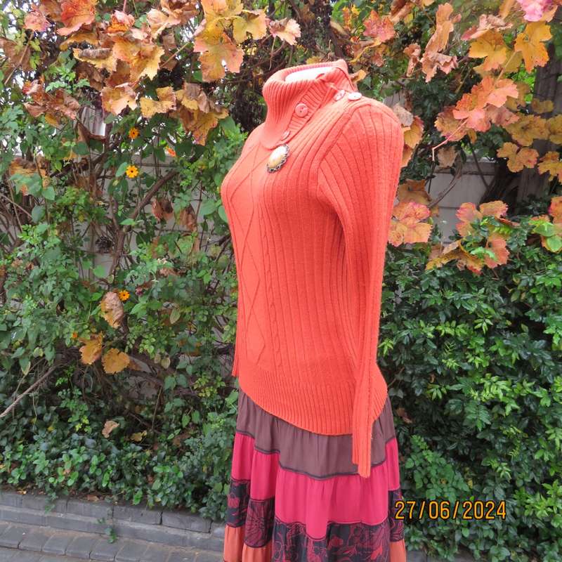 Burnt orange long sleeve poloneck sweater, size 34. Rayon/acrylic knit.