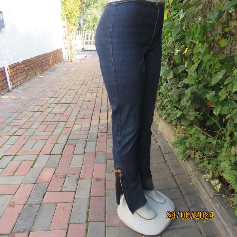 Bandless blue denim skinny jeans. Stretch polyester. High leg side slits.Leather tiestrings. Size 32