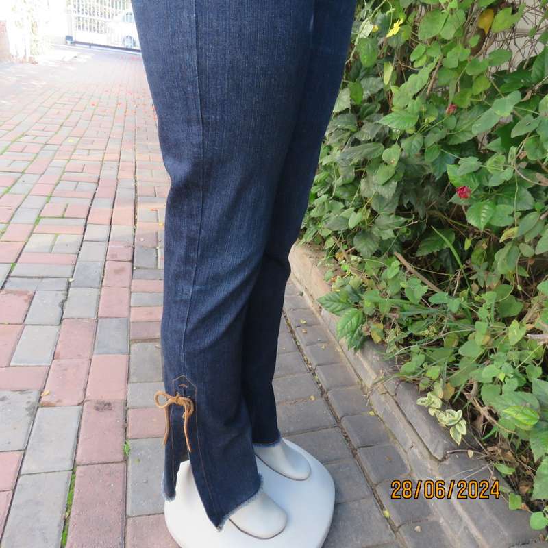 Bandless blue denim skinny jeans. Stretch polyester. High leg side slits.Leather tiestrings. Size 32