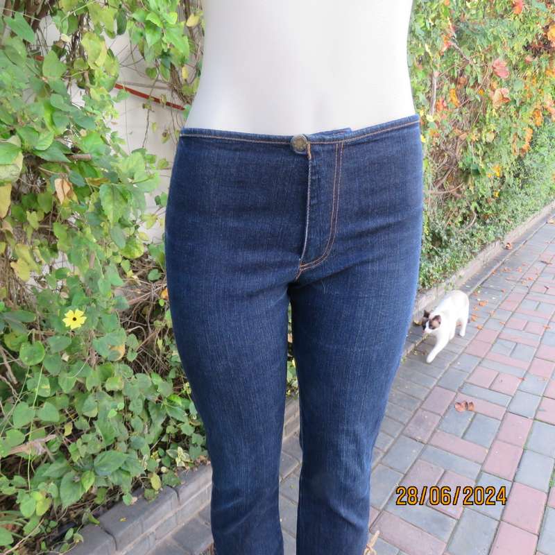 Bandless blue denim skinny jeans. Stretch polyester. High leg side slits.Leather tiestrings. Size 32