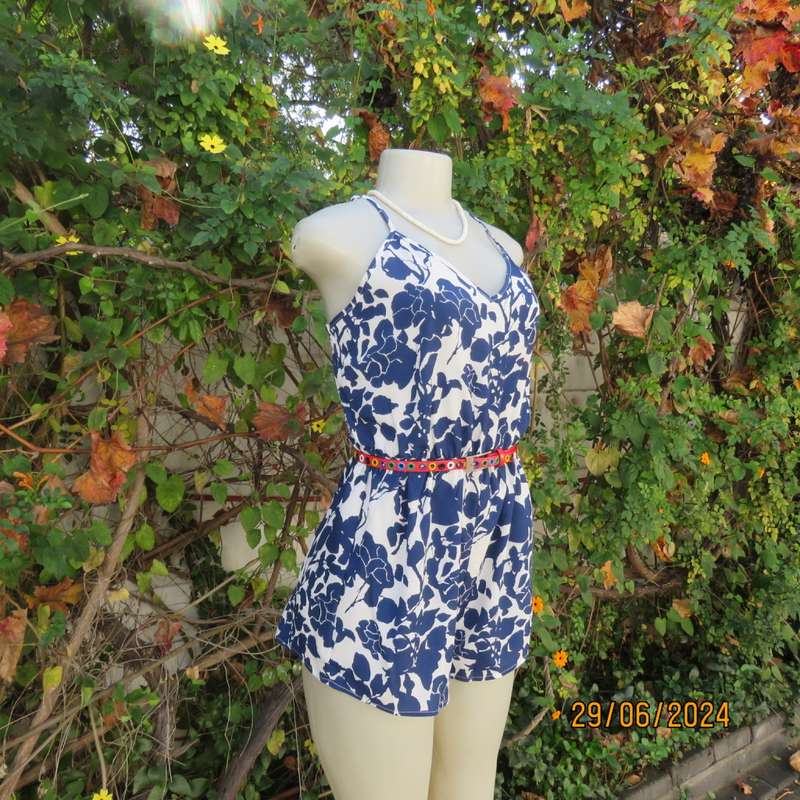 Summer romper in white with bold navy flowers. Elasticated waist. Size 36 by SHEIN. Brand new cond.