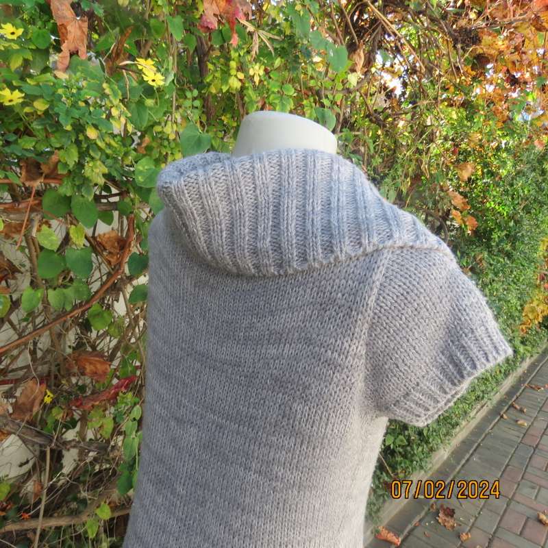 Double knit grey acrylic cardigan. Capped sleeves, button down with wide fold over collar.Size 36.