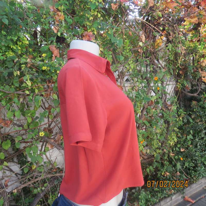 Cute burnt orange colour button down/shirt collar cropped top.One pocket. Size 34. As new.