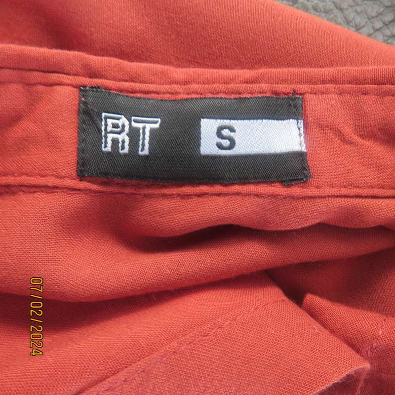 Cute burnt orange colour button down/shirt collar cropped top.One pocket. Size 34. As new.