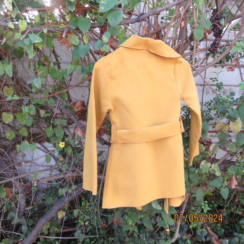 Mustard colour fold over warm jacket for 9 to 10 yr old girl. By IQ. Two pockets. Band around waist.