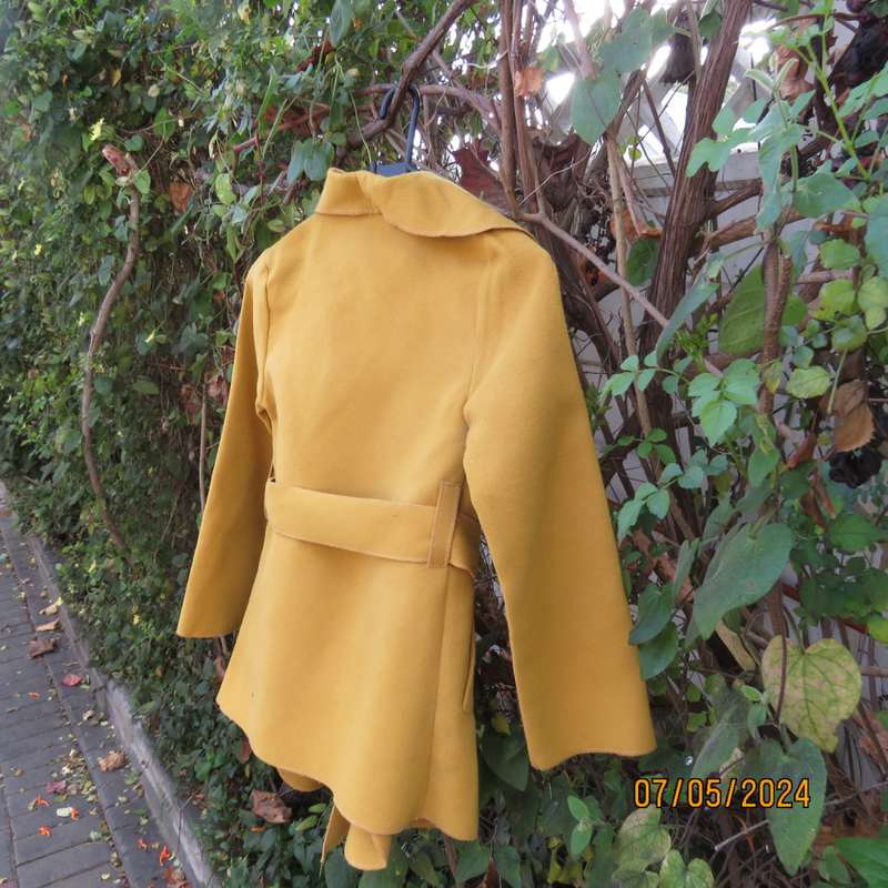 Mustard colour fold over warm jacket for 9 to 10 yr old girl. By IQ. Two pockets. Band around waist.