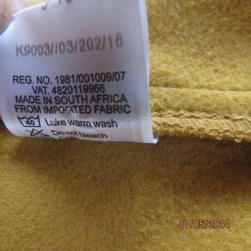 Mustard colour fold over warm jacket for 9 to 10 yr old girl. By IQ. Two pockets. Band around waist.