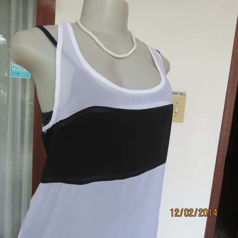 Sheer polyester slip over white sleeveless top with black horizontal stripe. By NEWS size 36. As new