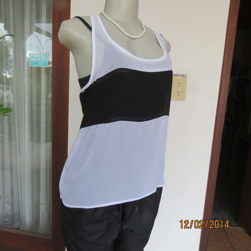 Sheer polyester slip over white sleeveless top with black horizontal stripe. By NEWS size 36. As new