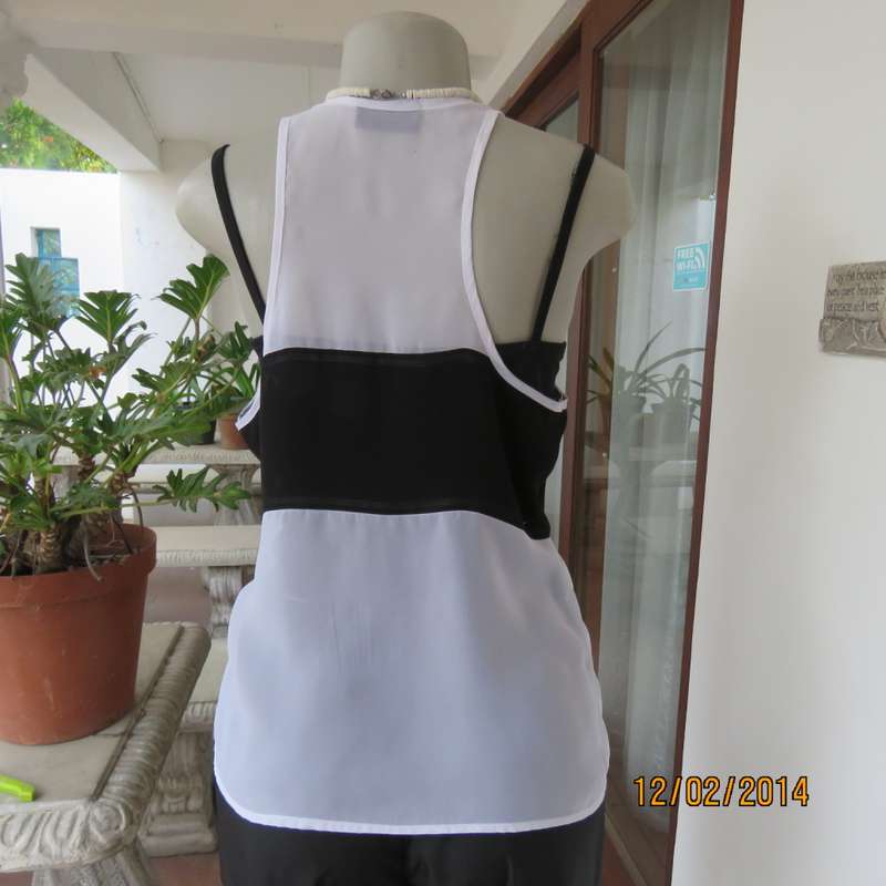 Sheer polyester slip over white sleeveless top with black horizontal stripe. By NEWS size 36. As new