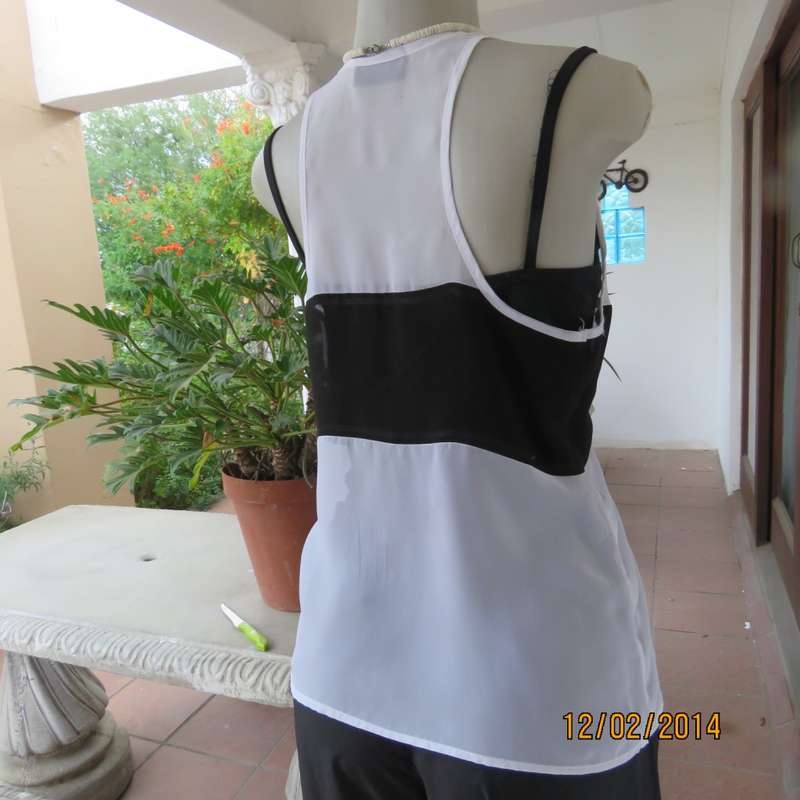 Sheer polyester slip over white sleeveless top with black horizontal stripe. By NEWS size 36. As new
