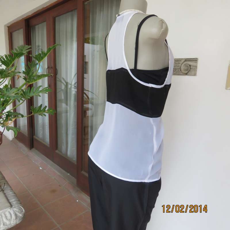 Sheer polyester slip over white sleeveless top with black horizontal stripe. By NEWS size 36. As new