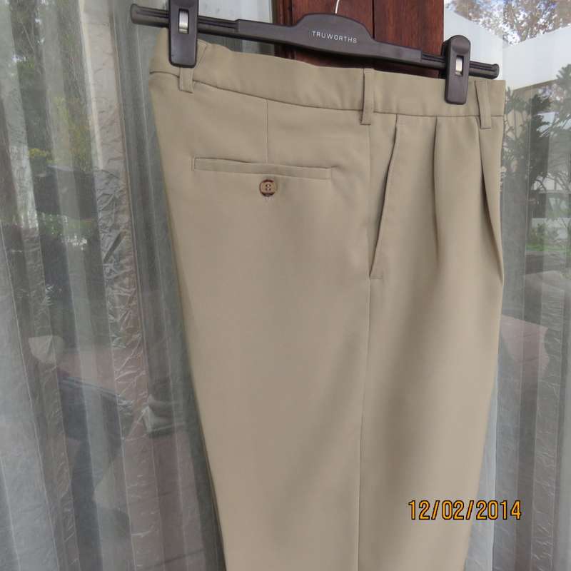 Well known MICHAEL RYAN pants size 35 in dark champagne polyester with stretch. New condition.