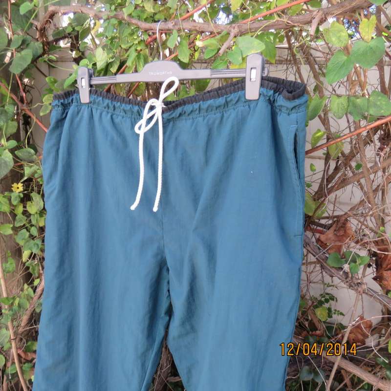 Men's dark jade tracksuit pants in nylon with polycotton stretch inner. Drawstring waist.Size XL.