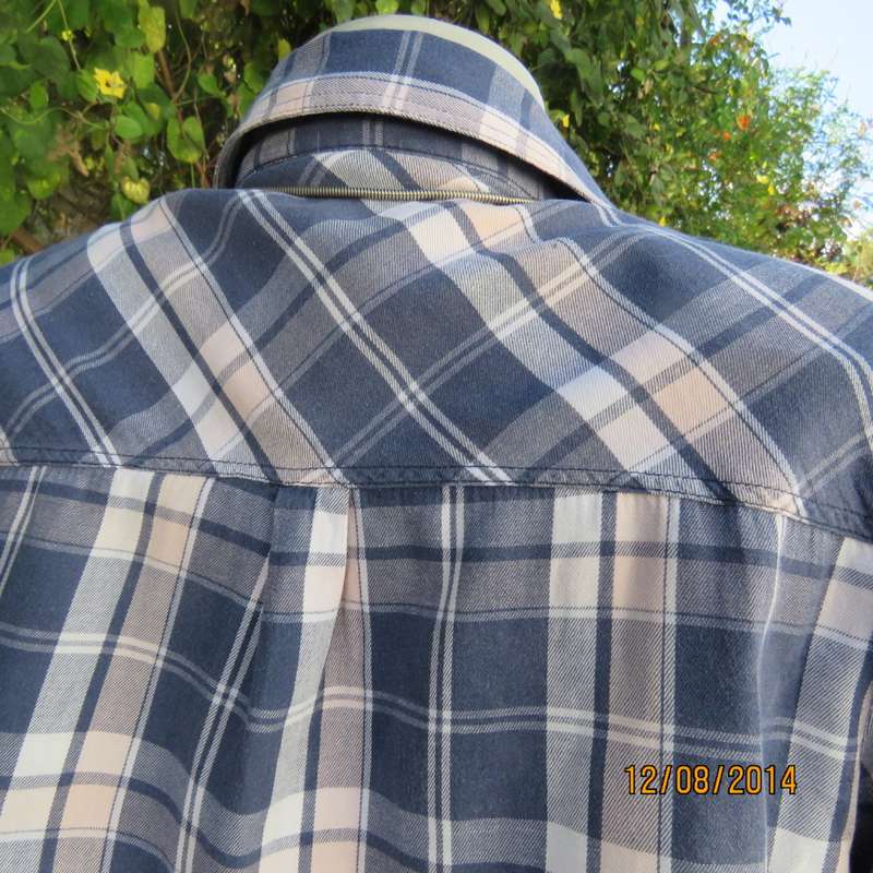 Casual long sleeve check button down top in blues.Peach touches. Two pockets.By IDENTITY.Size 36.