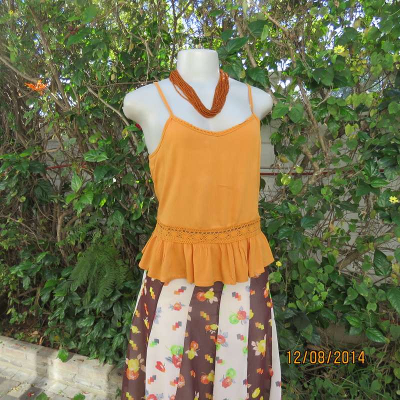 Cute pumpkin colour strappy top with peplum frill/lace decoration. Size 34 by RE. Very good cond.
