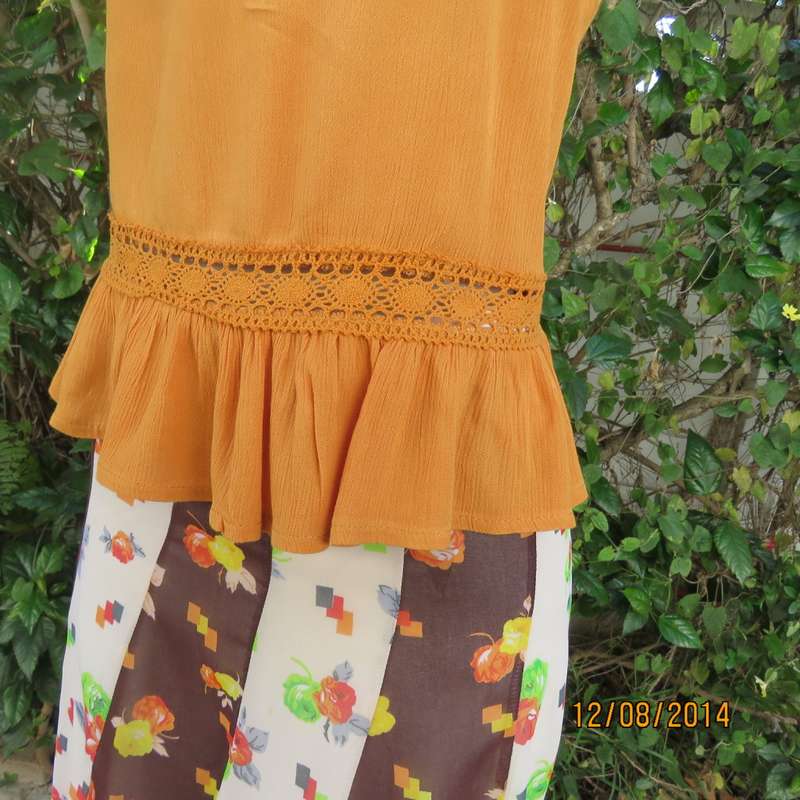Cute pumpkin colour strappy top with peplum frill/lace decoration. Size 34 by RE. Very good cond.