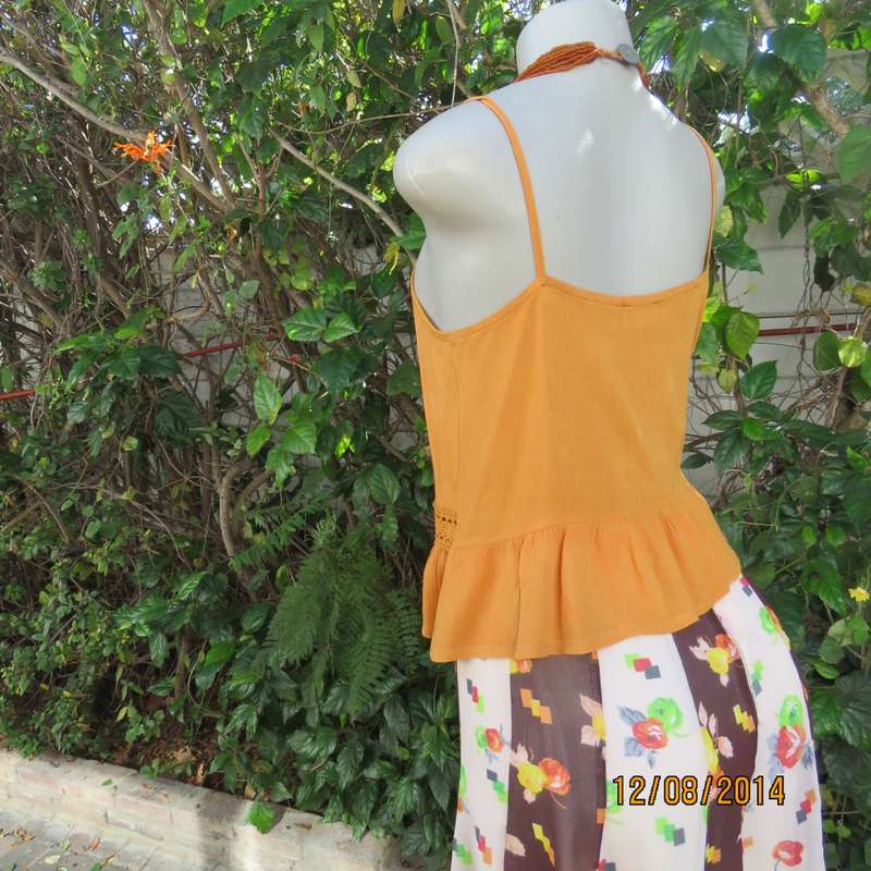 Cute pumpkin colour strappy top with peplum frill/lace decoration. Size 34 by RE. Very good cond.