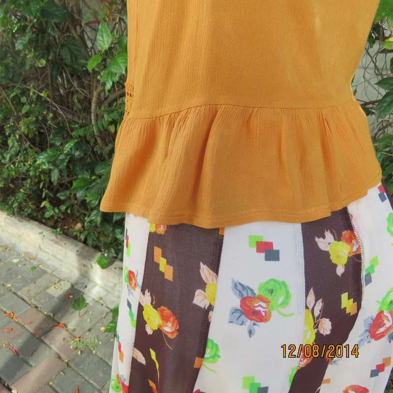 Cute pumpkin colour strappy top with peplum frill/lace decoration. Size 34 by RE. Very good cond.
