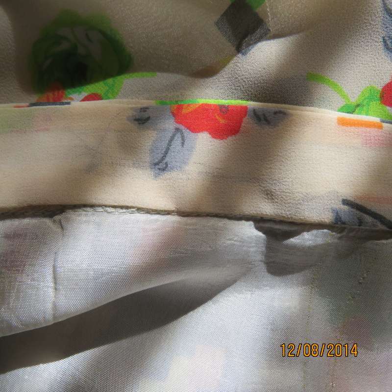 Uniquely paneled vintage sheer polyester brown/cream patterned size 34 skirt. Rounded hems. Back zip
