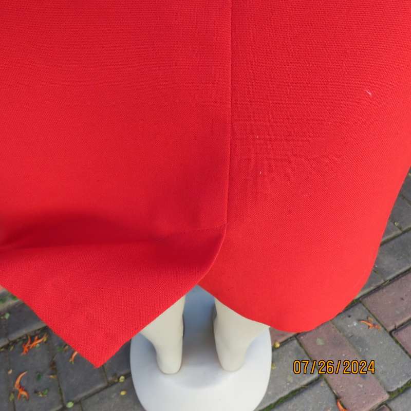 Bright red knee length lined pencil skirt in poly/viscose. By KELSO Petite size 35.Back zip/pleat.