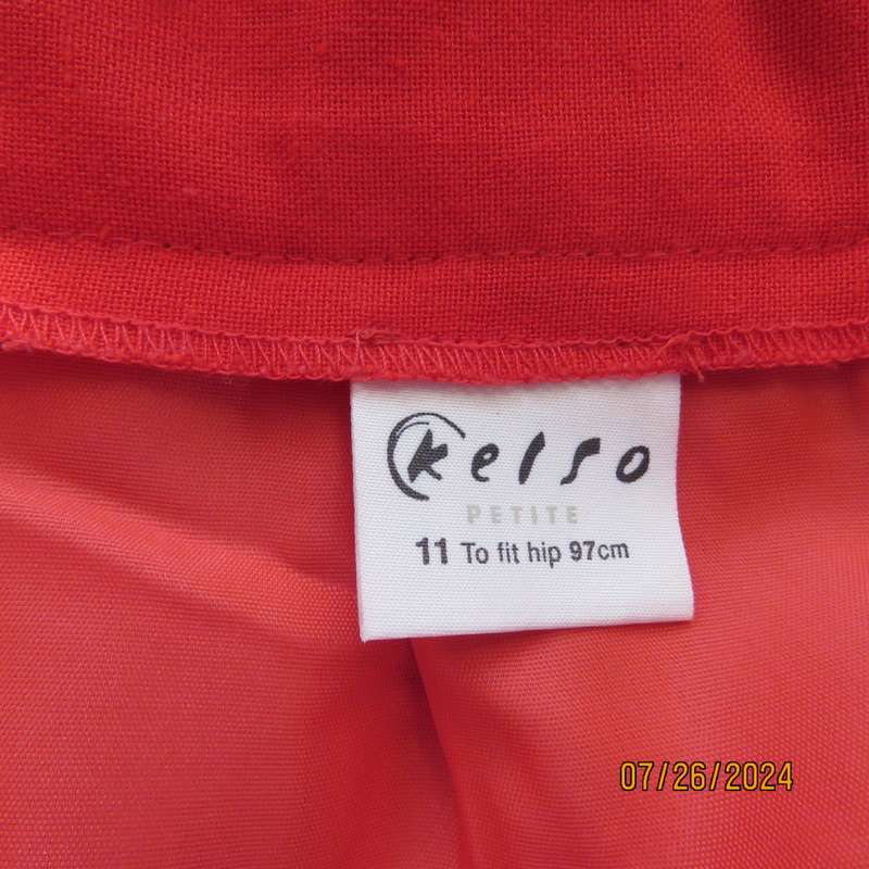 Bright red knee length lined pencil skirt in poly/viscose. By KELSO Petite size 35.Back zip/pleat.
