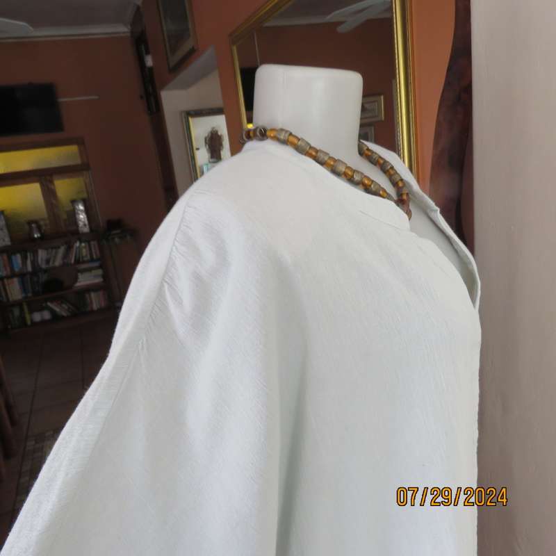 Creased cotton slip over soft mint green top. Short cut-on sleeves. Gathering at back.Size 40.V neck