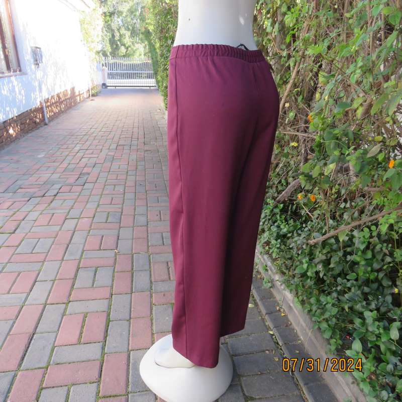 As new ladies trousers in plum polyester by TRUWORTHS size 36/12. Tapered legs. Elastic waist back.