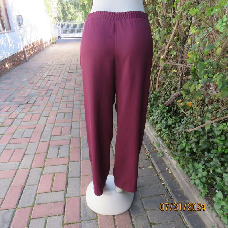 As new ladies trousers in plum polyester by TRUWORTHS size 36/12. Tapered legs. Elastic waist back.