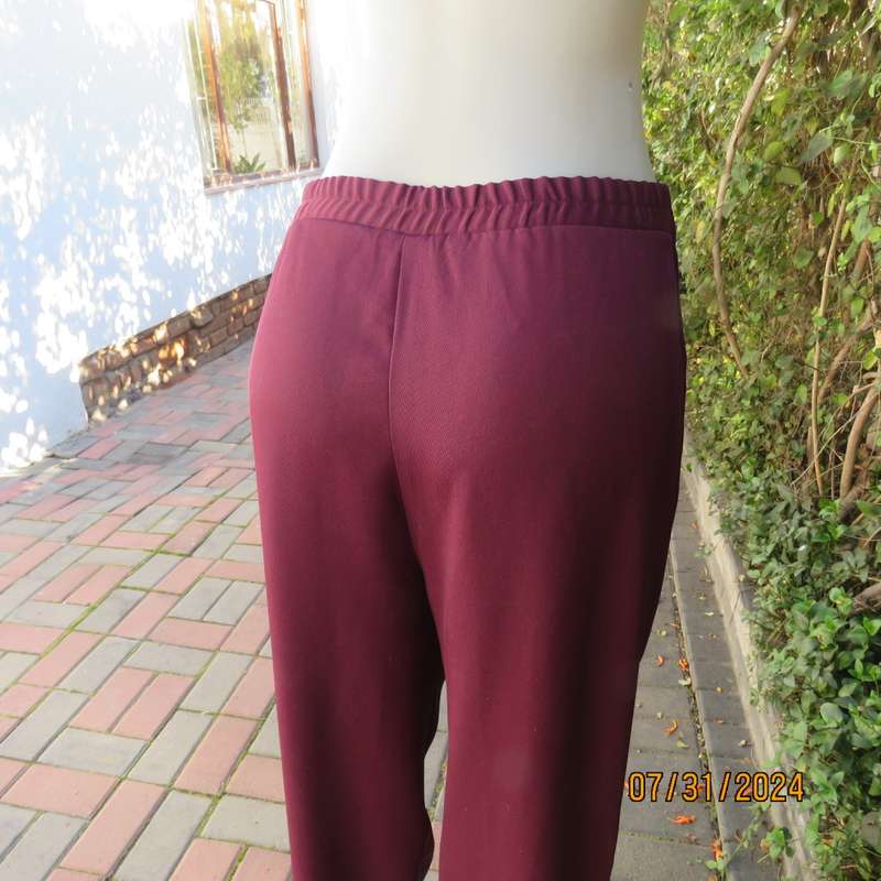 As new ladies trousers in plum polyester by TRUWORTHS size 36/12. Tapered legs. Elastic waist back.