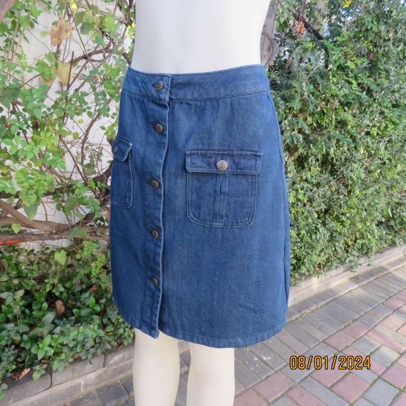 Button down blue jean knee length skirt in polycotton denim. Size 36. Front pockets. As new