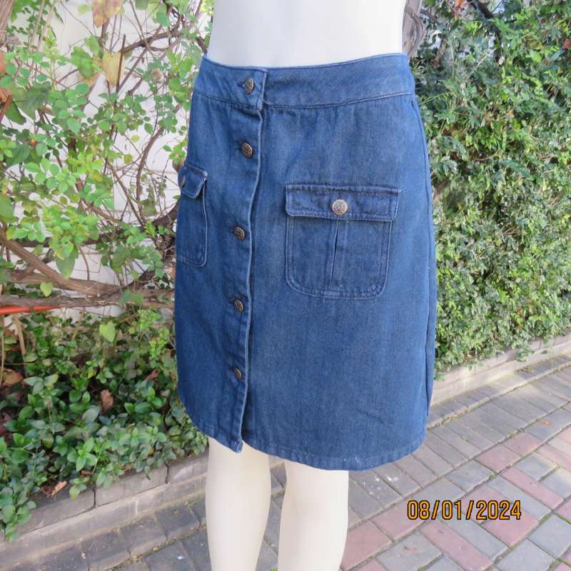 Button down blue jean knee length skirt in polycotton denim. Size 36. Front pockets. As new