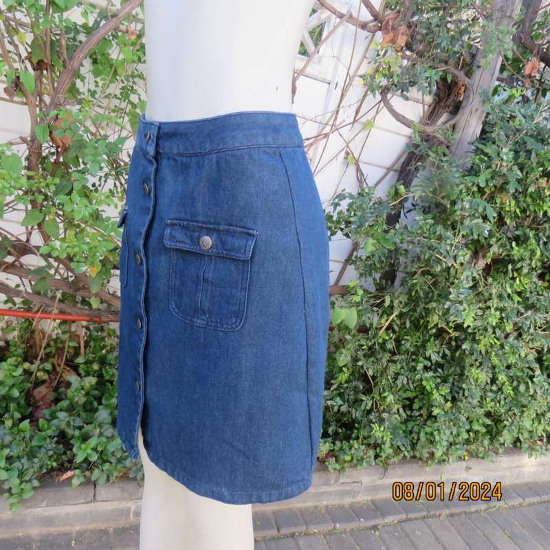 Button down blue jean knee length skirt in polycotton denim. Size 36. Front pockets. As new