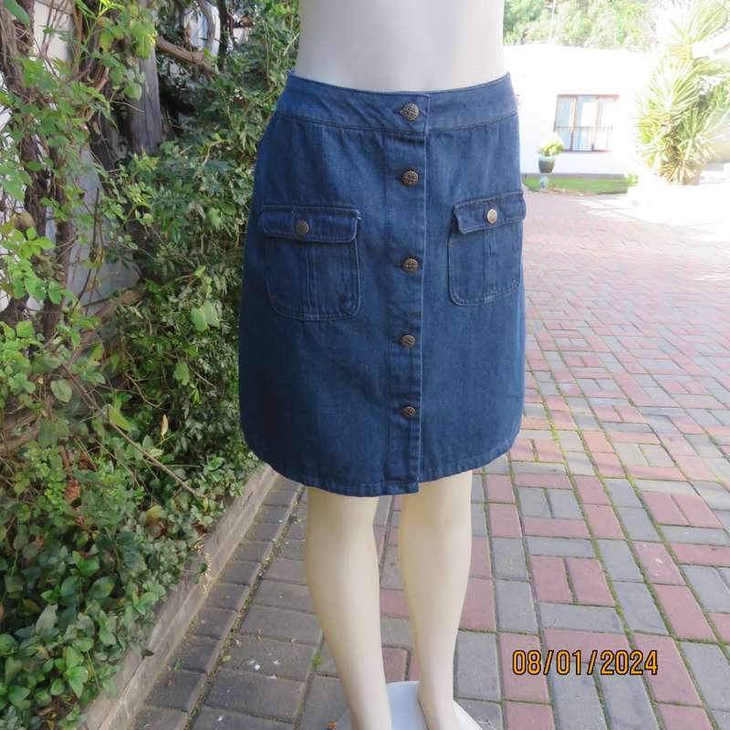 Button down blue jean knee length skirt in polycotton denim. Size 36. Front pockets. As new