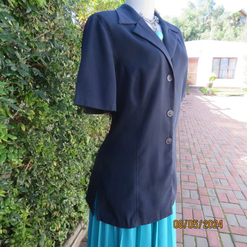 Classic navy button down princess cut short sleeve jacket. Notched collar.Size 38 by TOPICS.