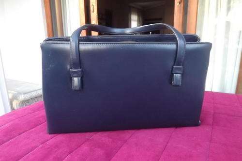 Navy Handbag in good condition - lots of packing space - studs at the bottom to stand - 21x35cm