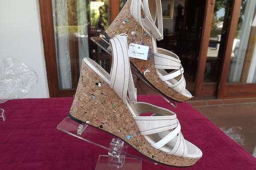 Pair of beige anklestrap sandles with wedged cork heels by Robo in size 40/7.Store sample-brand new