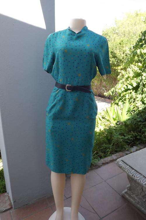 Turquoise 100% viscose fitted dress with high folded neckline.Size 32/8.Belt excluded.Good condition