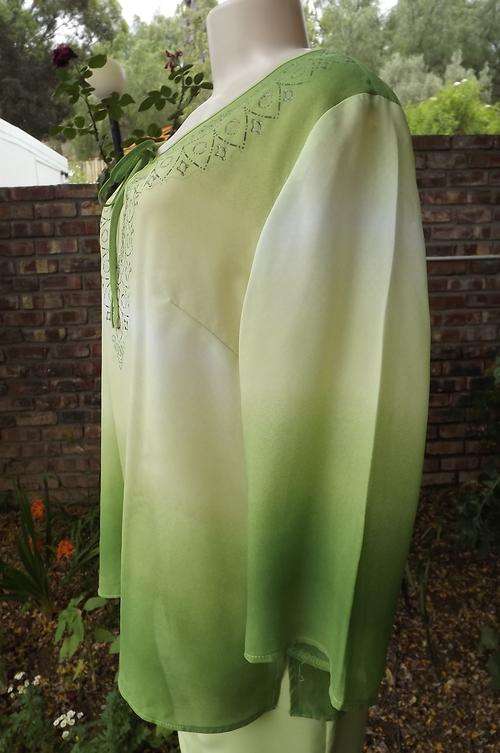 Green shaded 3 quarter sleeve polyester top.Size 40/16.Glimmer decorated neckline with tie string.