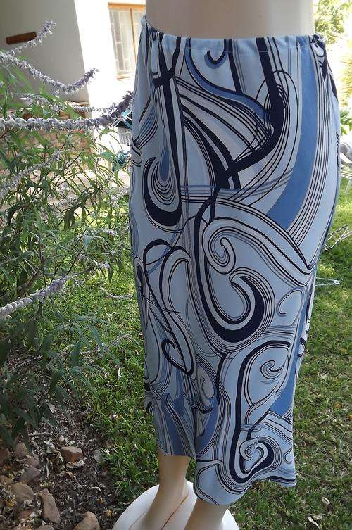 Geometrically printed 100% polyester A line skirt in different blues.Size 36/12 by Aspire.New