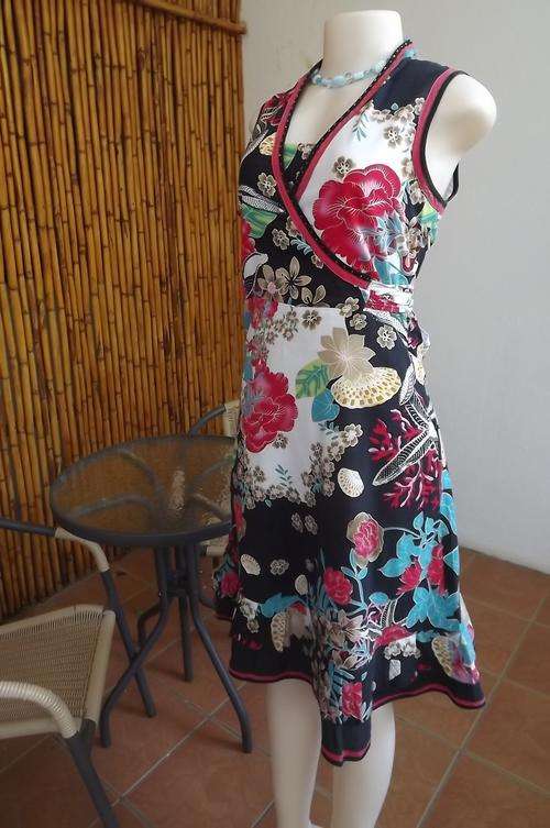 Cheerful floral dress in white with Japannese design.Crossover top with strap to tie around waist.