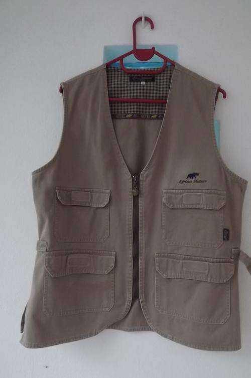 Waistcoat from African Nature CO in size medium.Khaki with olive zip and 4 front pockets.