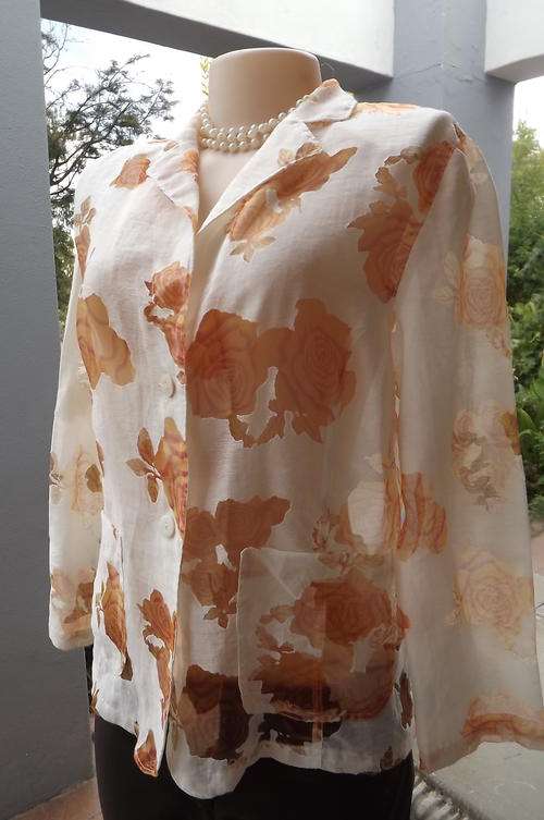 Stunning sheer beige summer jacket with orange colour see-through rose design.Size 36/12 by Onores